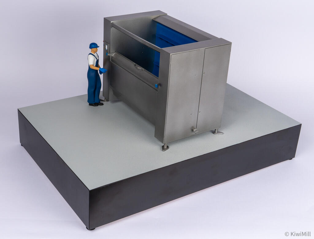 Elevated left three-quarter view of the belt chiller model showing end panel doors and blue belt inside the open top